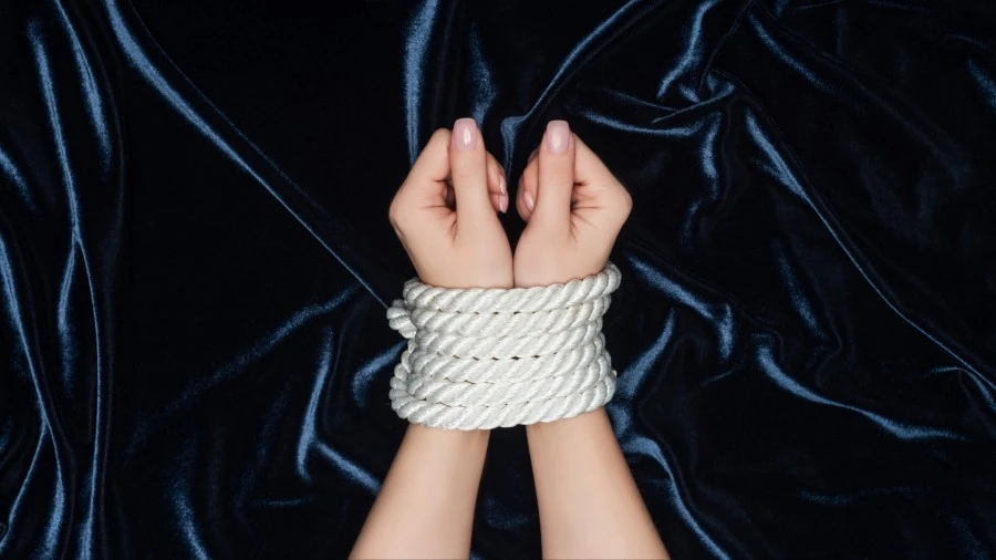 Photo of hands tied with a rope