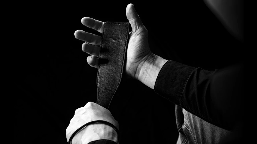 Black and white photo of a man holding a paddle